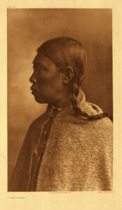 Edward Curtis sepia portrait of a Lummi woman in traditional dress, 1913