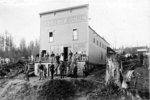 Around 1900 photograph of the Everett House restaurant and grocery store storefront in Whatcom County