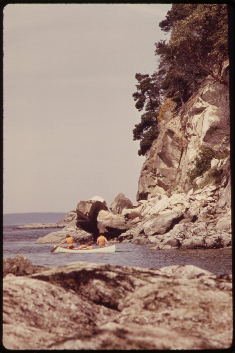 1973 color photograph of people canoeing on Puget Sound off Larrabee State Park near Bellingham