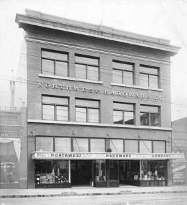 Around 1909 photo of the Northwest Hardware Company storefront in downtown Bellingham with streetcar tracks