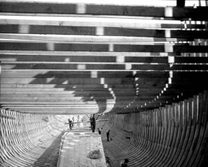 Interior of a wooden ship hull under construction in a shipyard, 1916