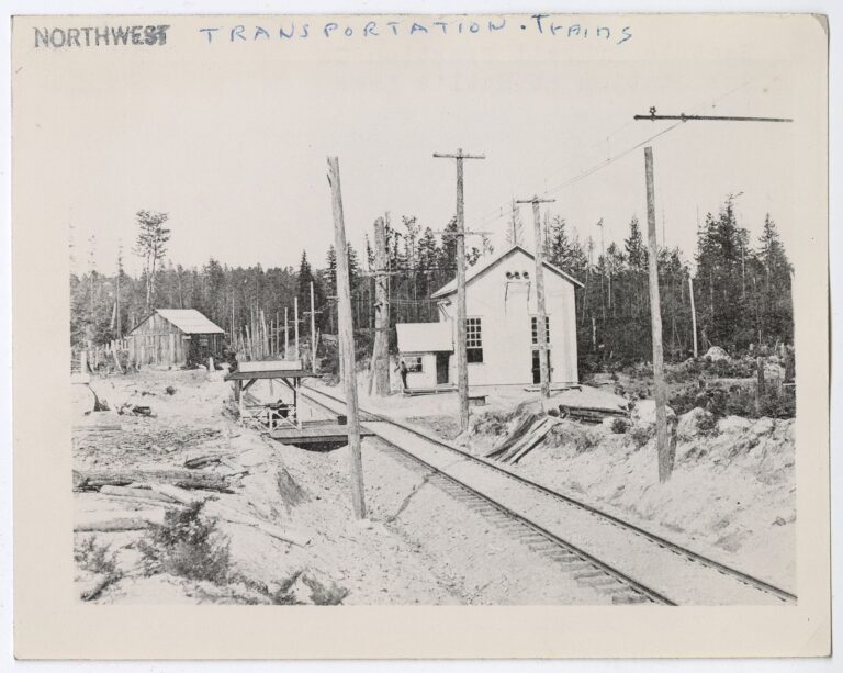 An early electric interurban railcar with men standing alongside it on opening day
