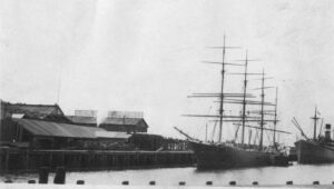 1916 photo of a sailing ship and a steamship moored together at the Bloedel-Donovan lumber dock