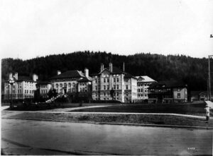 1914 photo of the State Normal School building on a wooded hill above Bellingham