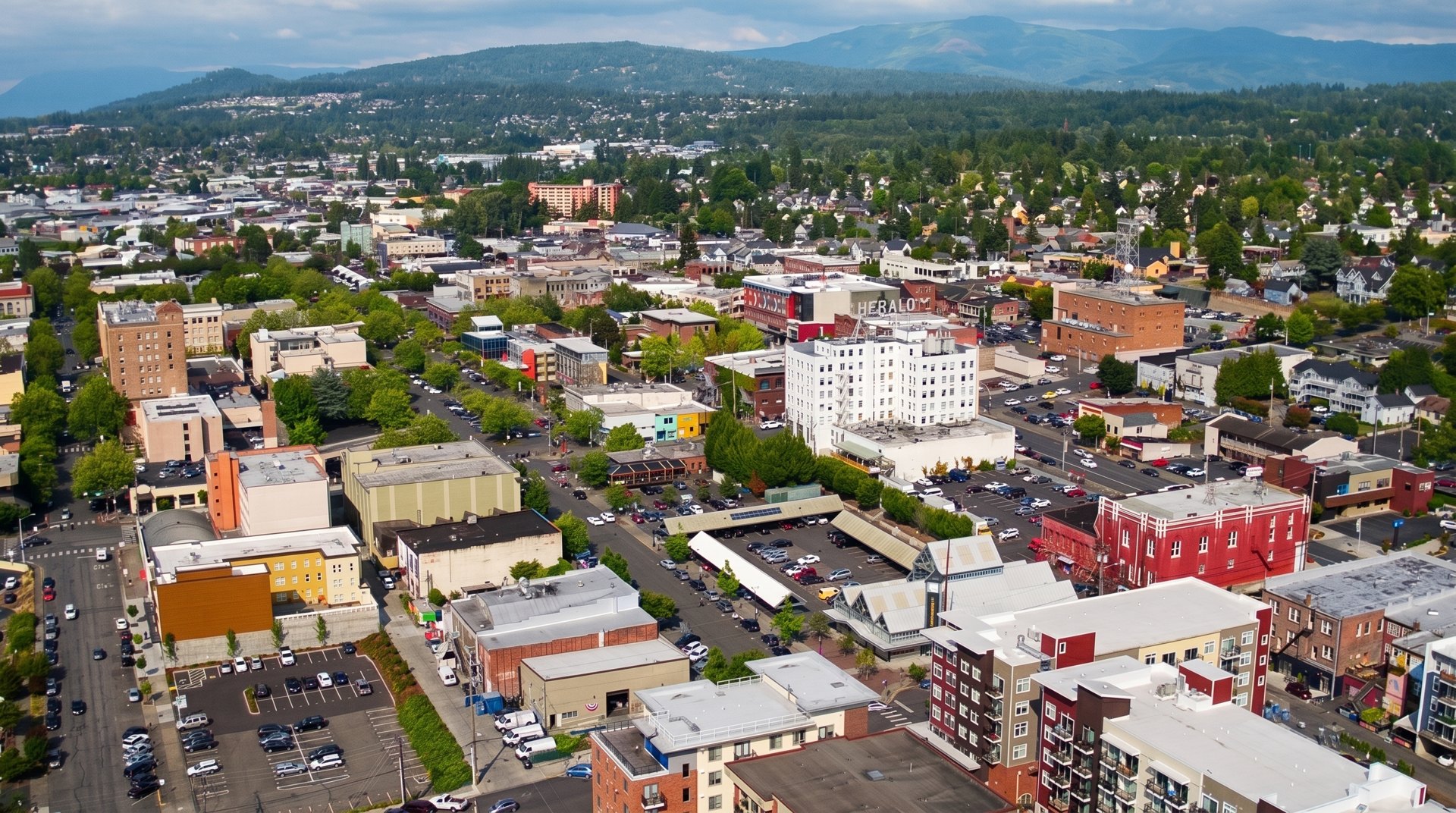 Aerial drone view over downtown Bellingham's street grid with Sehome hill behind