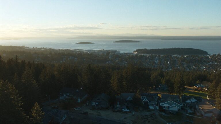 Forested Chuckanut Mountain hills above the Salish Sea and the San Juan Islands