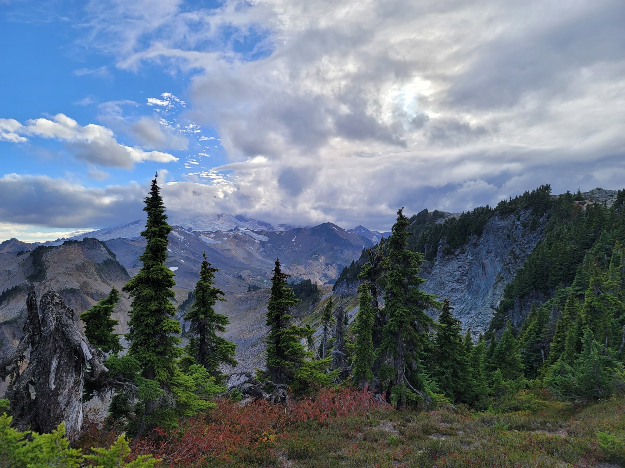 Mount Baker wreathed in cloud above a fall-colored meadow at Artist Point